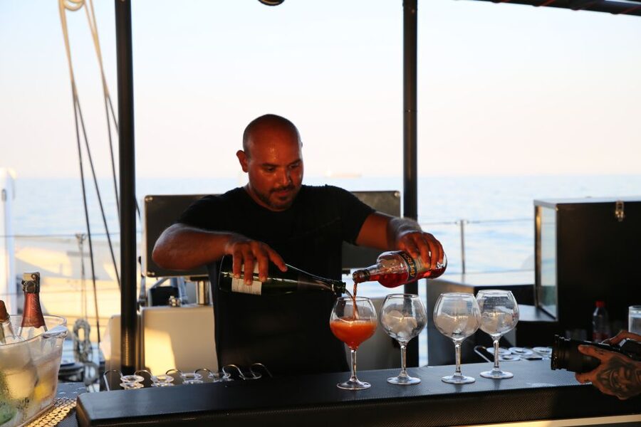 Cambrils: Sunset Catamaran Cruise with Drinks - Sunset moments: lounge views behind the mountains of the Costa Dorada