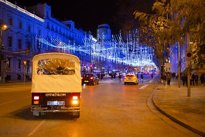 Christmas Lights Tour of Madrid in Eco Tuk Tuk Private - Puerta de Alcalá: The Monumental Gate Illuminated by History