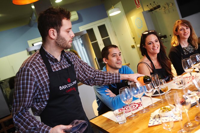 Interactive Paella & Market: Bottomless Wine & Rambla Views - From shopping bags to kitchen stations, everyone cooks