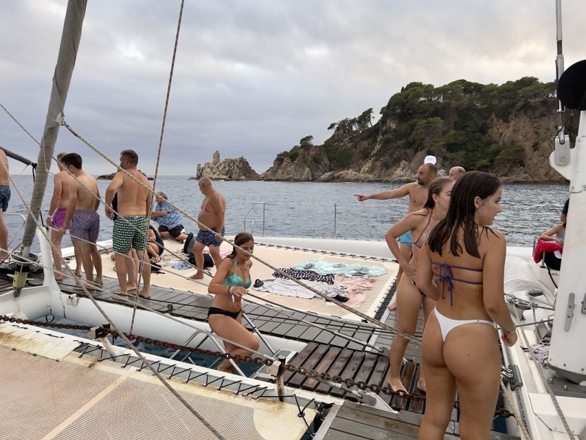 Lloret de Mar: Sunset Catamaran Cruise with DJ and Drinks - Cruising the Costa Brava Shoreline at Golden Hour