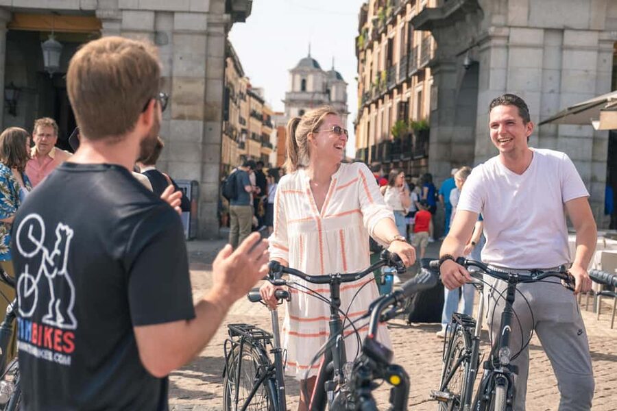 Madrid: Highlights Bike Tour with Optional E-Bike or Tapas - Plaza de Oriente, the Royal Palace area, and Almudena Cathedral stories