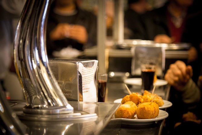 Madrid Local's Tapas Tour Dinner with a side of History - Puerta del Sol at Night, Time Facts, and 12 Grapes Logic
