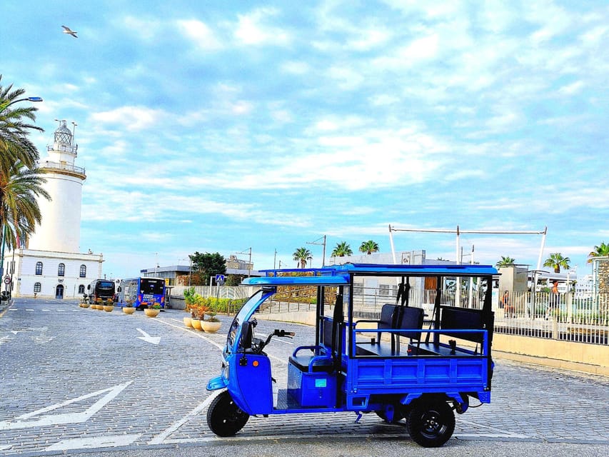 Malaga: Tuk tuk tour - The ride experience: open-air comfort, rain covers, and small-group ease