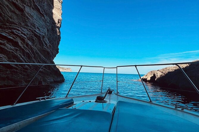 Mallorca Beach & Caves 4hr Boat Trip Drinks, Tapas, SUP & Snorkel - Alcanada Island: the relaxed finish with snacks, SUP, and lighthouse views