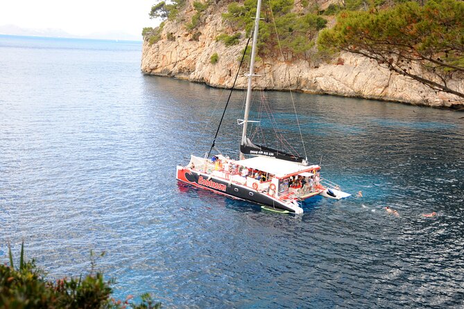 Mallorca Catamaran Tour in the Bay of Pollensa - Formentor Beach, the pine forest, and the watchtower above